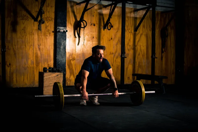 Ahşap duvarlı salonda deadlift yapan bir sporcu